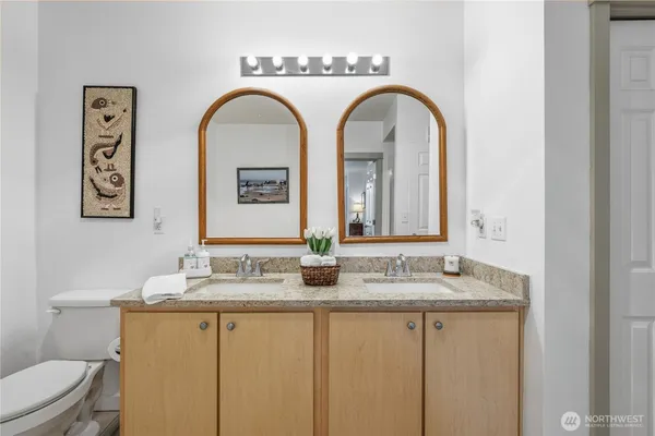 a bathroom with a granite countertop sink mirror and shower