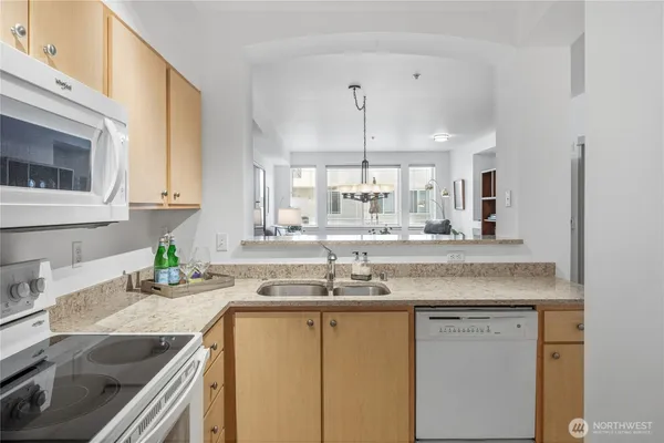 a kitchen with a stove oven and sink