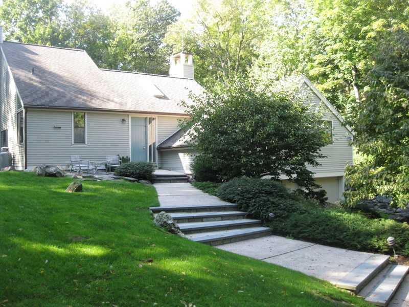a front view of a house with garden