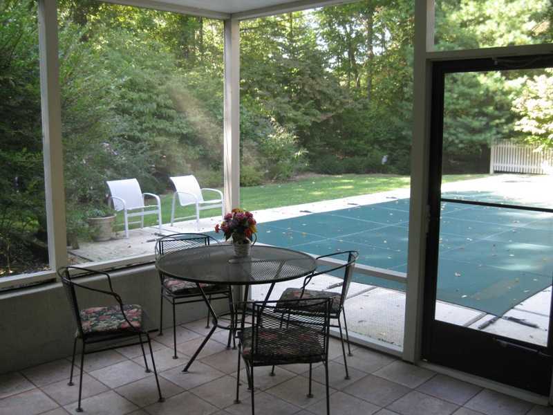 29 Angus Lane Greenwich, CT 06831 - Photo 13 of 14 a view of an outdoor kitchen with a table and chairs in patio