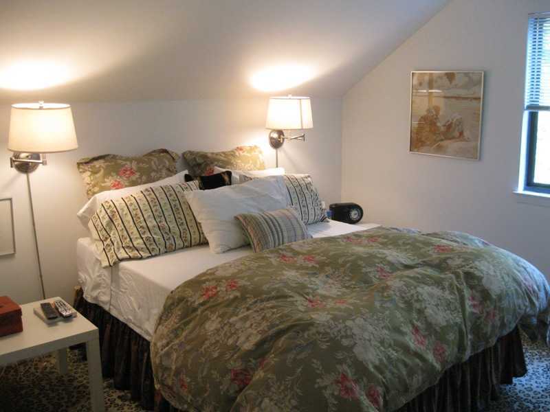 29 Angus Lane Greenwich, CT 06831 - Photo 8 of 14 a bedroom with a bed and wall painting
