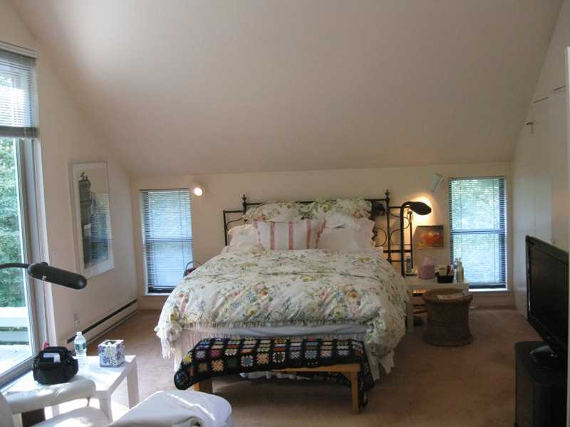 29 Angus Lane Greenwich, CT 06831 - Photo 10 of 14 a bedroom with a bed chair and mirror on the dresser
