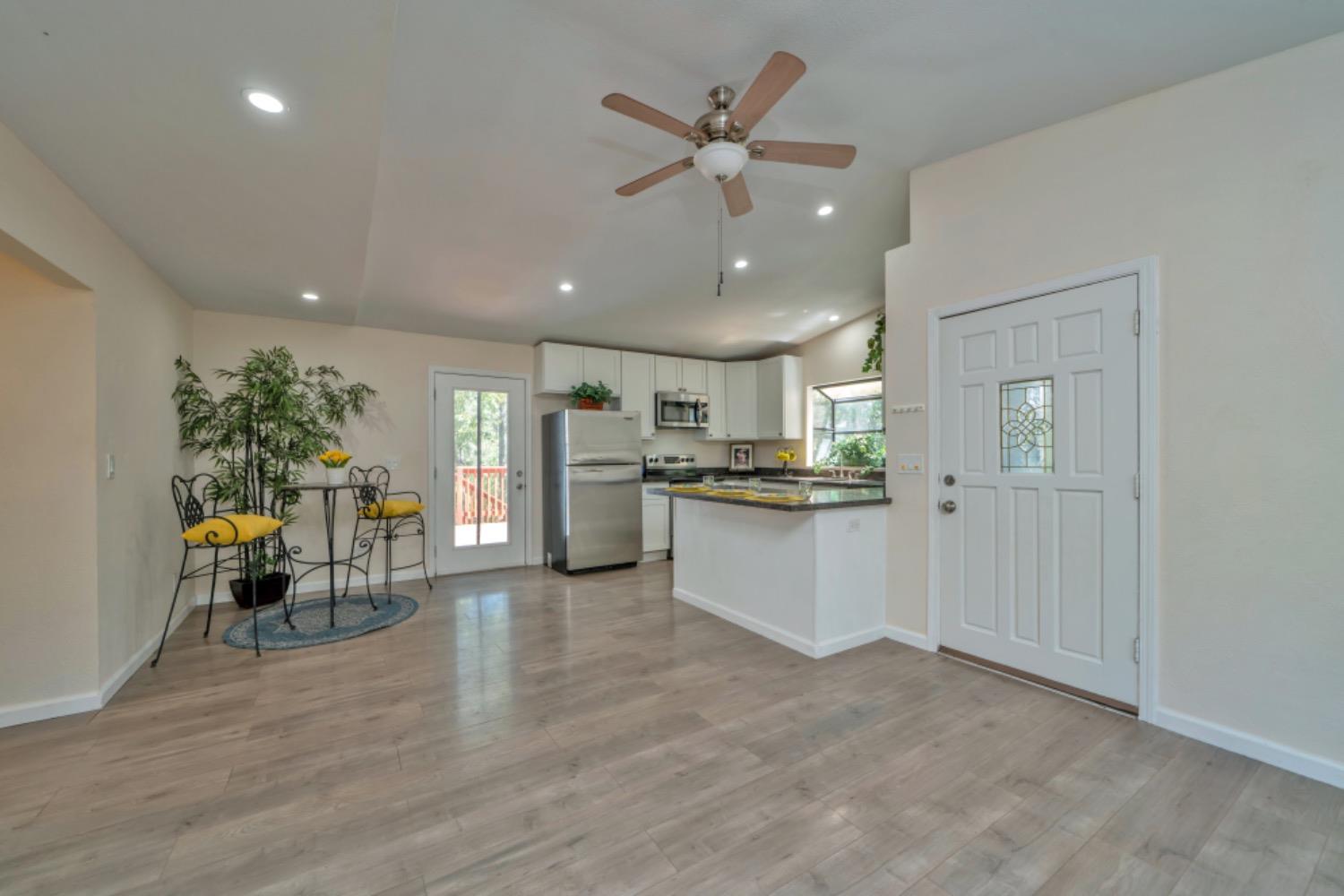a view of kitchen with furniture and refrigerator
