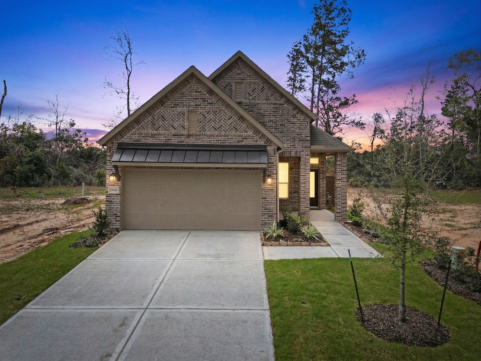 12806 Meadow Wind Way Conroe, TX 77302 - Photo 1 of 37 a front view of a house with garden