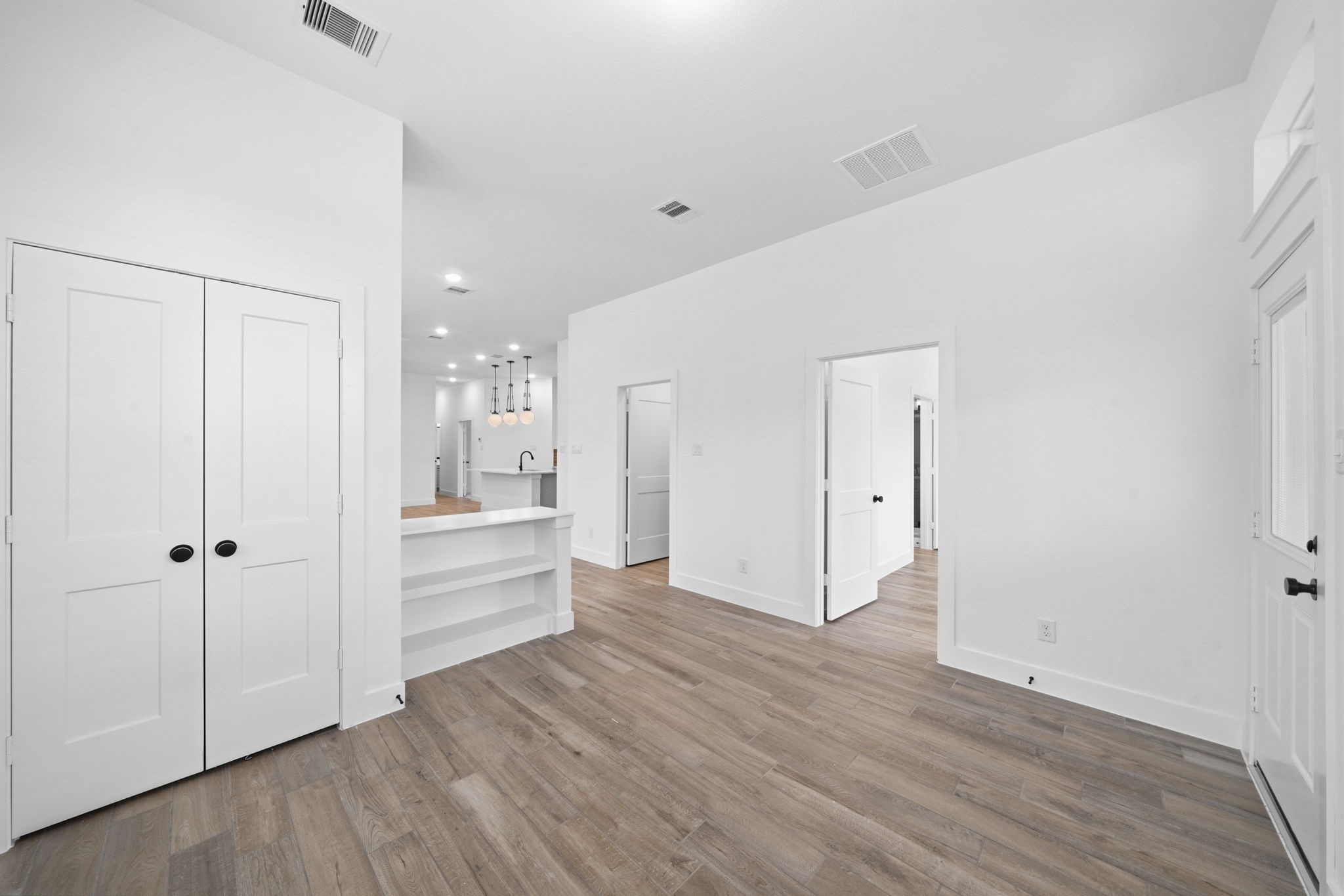 12806 Meadow Wind Way Conroe, TX 77302 - Photo 14 of 37 a view of a hallway with wooden floor and a bathroom