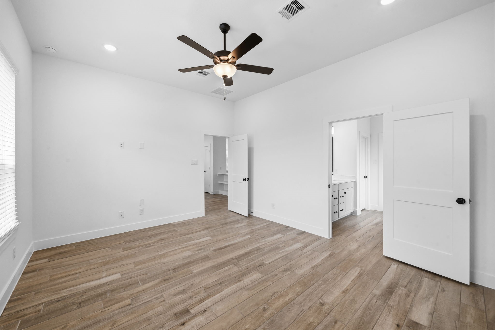12806 Meadow Wind Way Conroe, TX 77302 - Photo 16 of 37 an empty room with wooden floor and a ceiling fan