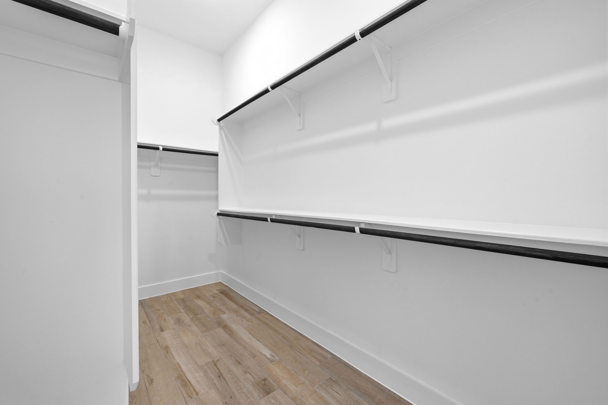12806 Meadow Wind Way Conroe, TX 77302 - Photo 19 of 37 a view of walk in closet with empty racks
