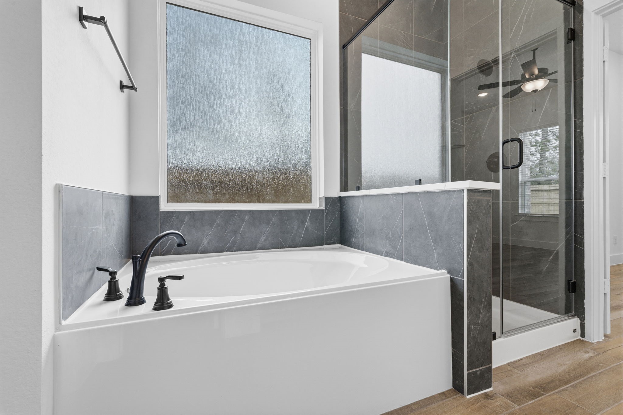 12806 Meadow Wind Way Conroe, TX 77302 - Photo 20 of 37 a bathroom with a bathtub and a shower