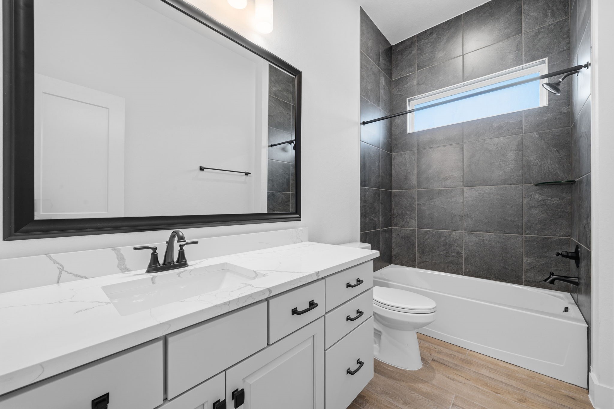 12806 Meadow Wind Way Conroe, TX 77302 - Photo 21 of 37 a bathroom with a sink a toilet and a large mirror