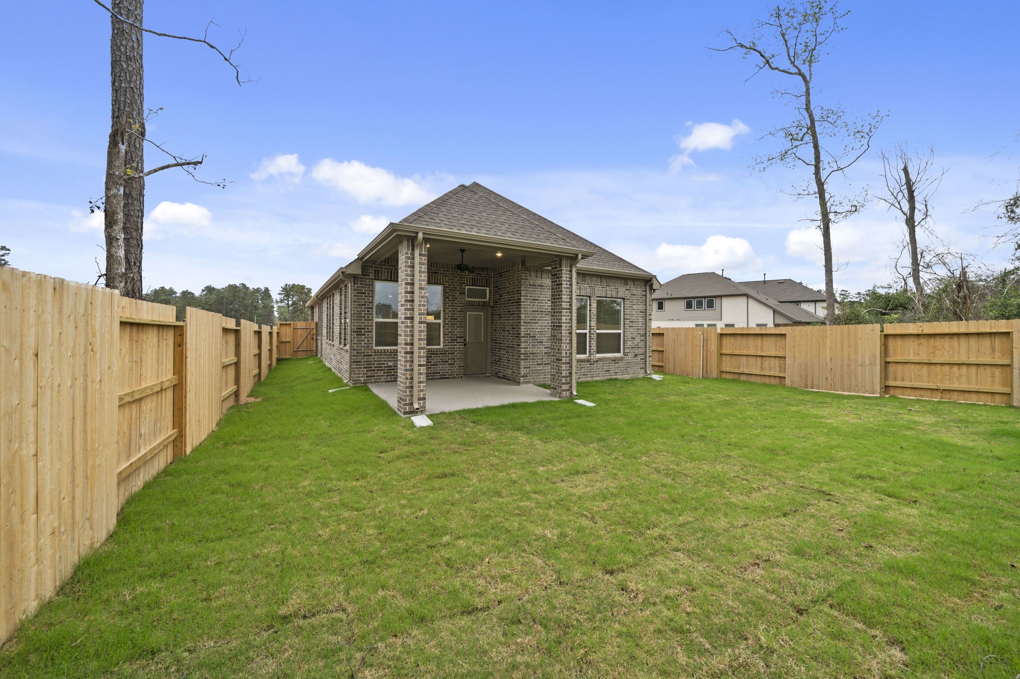 12806 Meadow Wind Way Conroe, TX 77302 - Photo 24 of 37 a view of a house with a yard