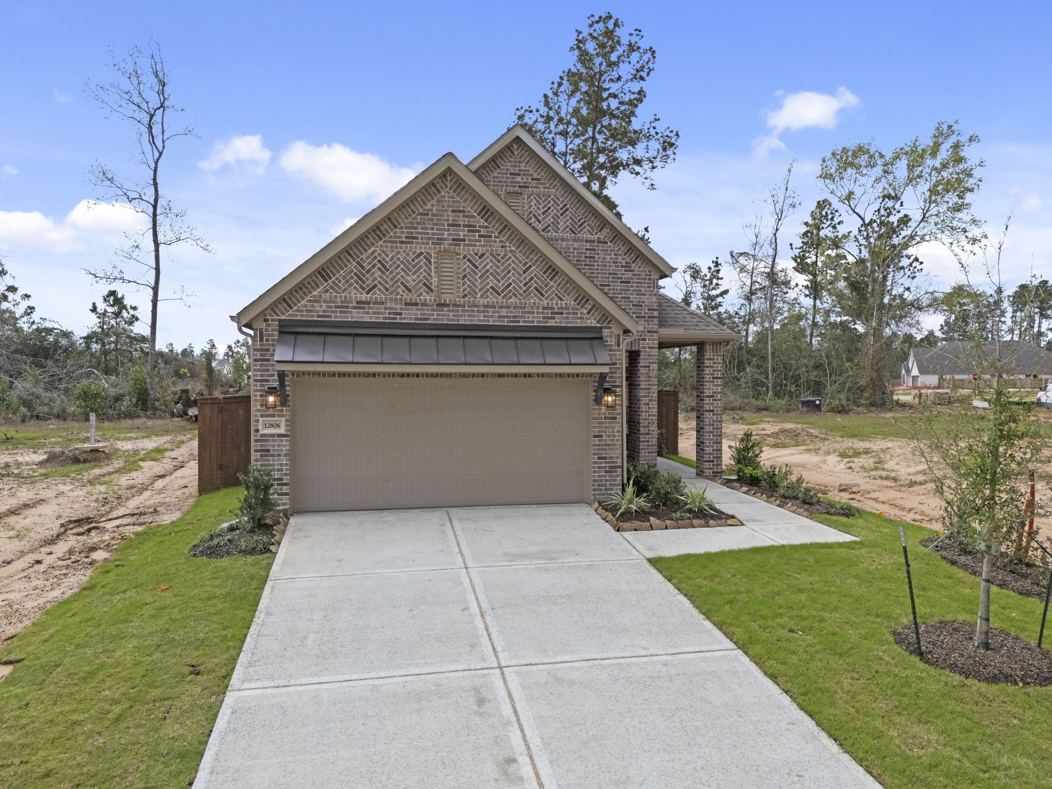 12806 Meadow Wind Way Conroe, TX 77302 - Photo 28 of 37 a front view of a house with garden