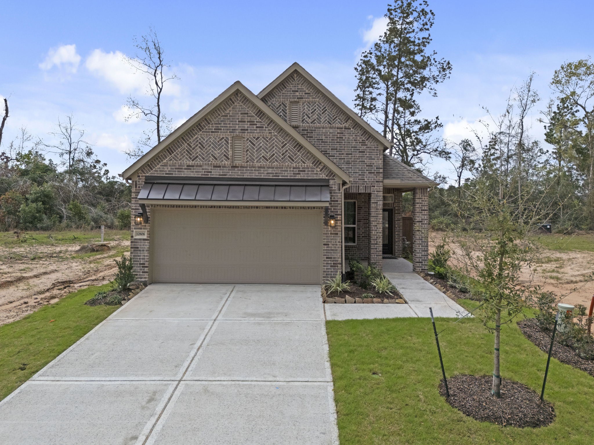 12806 Meadow Wind Way Conroe, TX 77302 - Photo 29 of 37 a front view of a house with garden