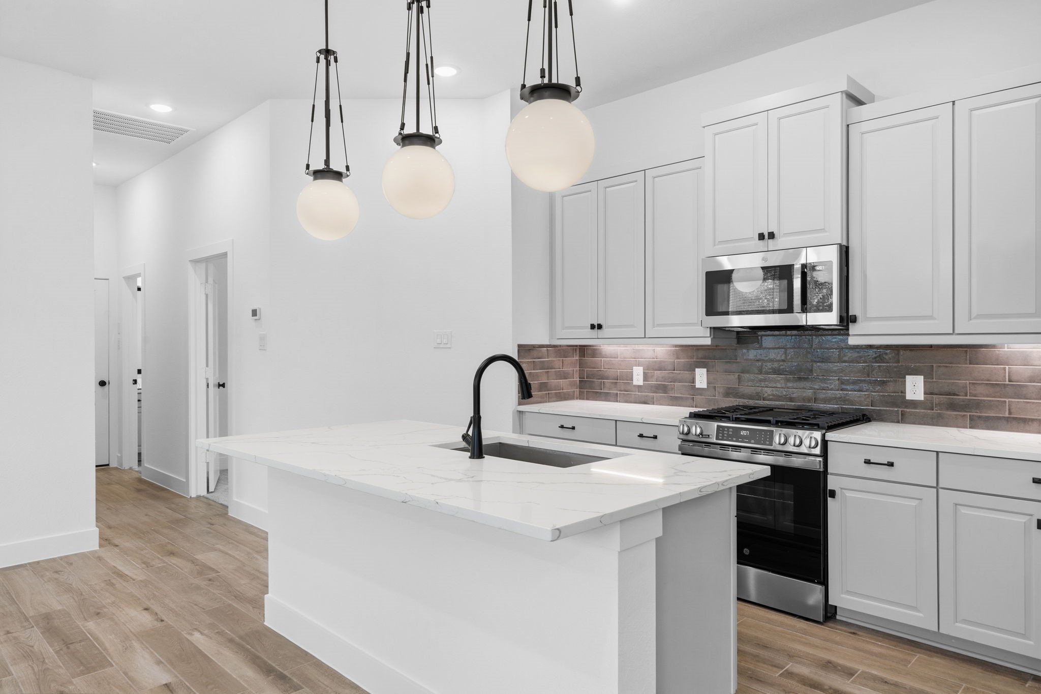 12806 Meadow Wind Way Conroe, TX 77302 - Photo 5 of 37 a kitchen with stainless steel appliances granite countertop a sink a stove and a refrigerator