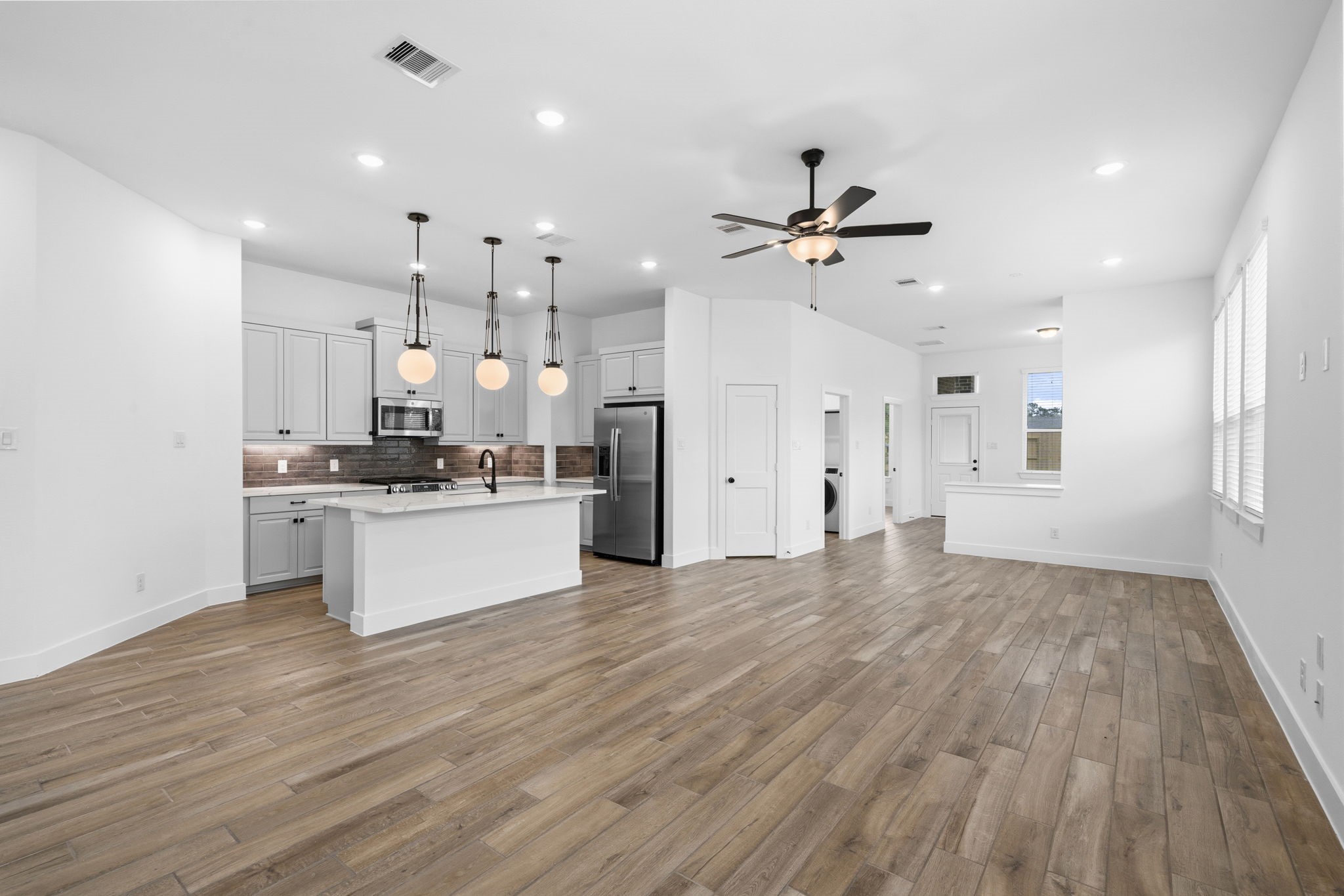 12806 Meadow Wind Way Conroe, TX 77302 - Photo 6 of 37 a view of kitchen with refrigerator microwave and stove