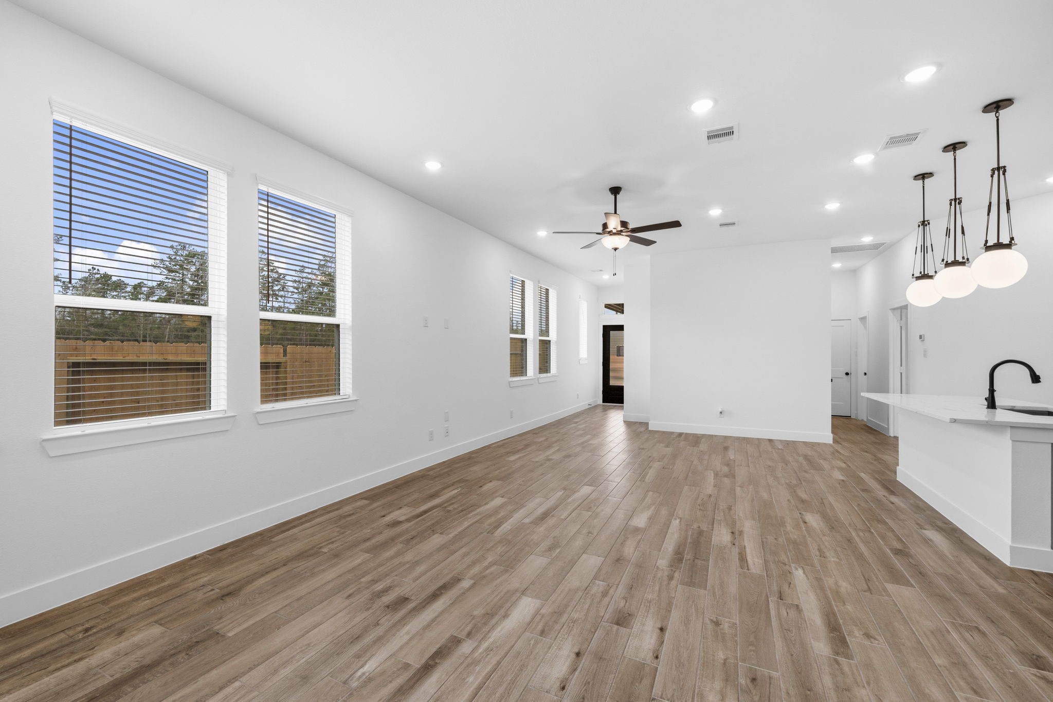 12806 Meadow Wind Way Conroe, TX 77302 - Photo 8 of 37 an empty room with wooden floor and windows