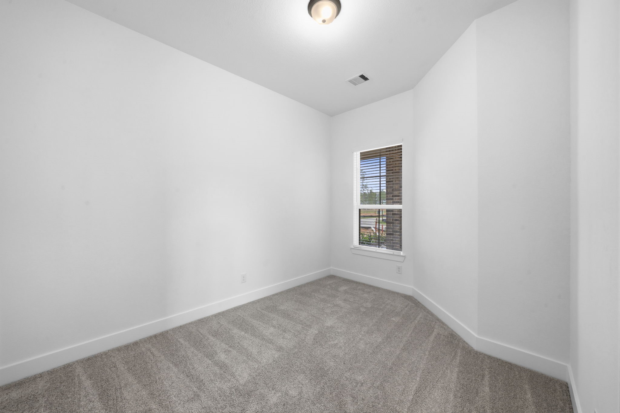 12806 Meadow Wind Way Conroe, TX 77302 - Photo 9 of 37 a view of an empty room with a window