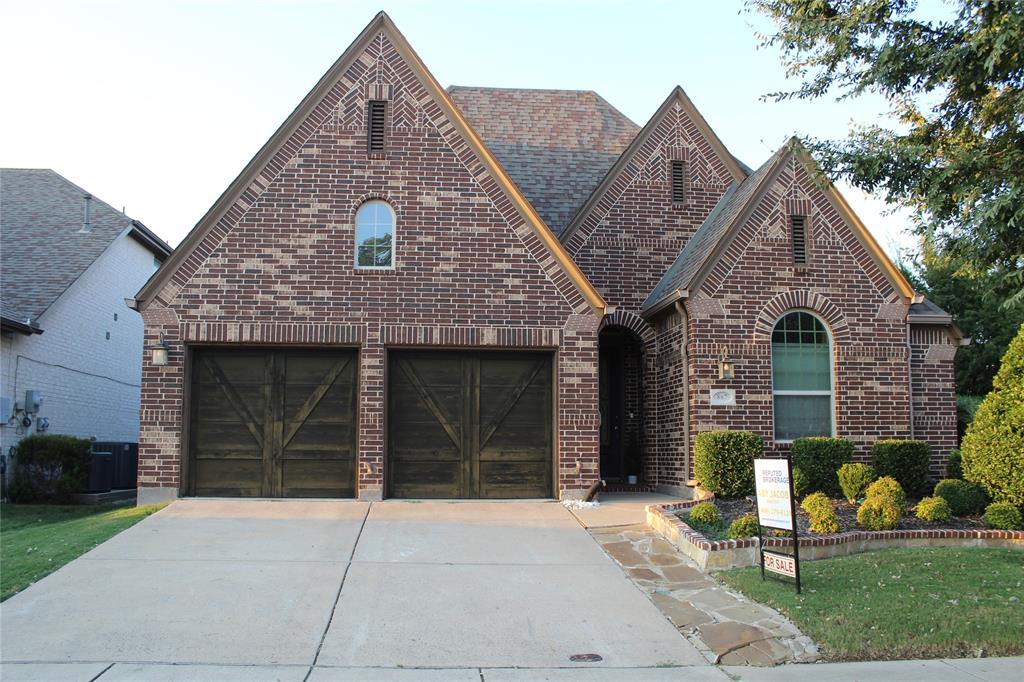 867 Forest Street Little Elm, TX 76227 - Photo 1 of 22 a front view of a house with a garden and plants