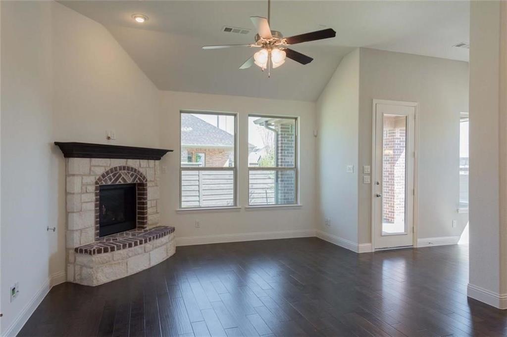 867 Forest Street Little Elm, TX 76227 - Photo 12 of 22 a living room with fireplace and wooden floor