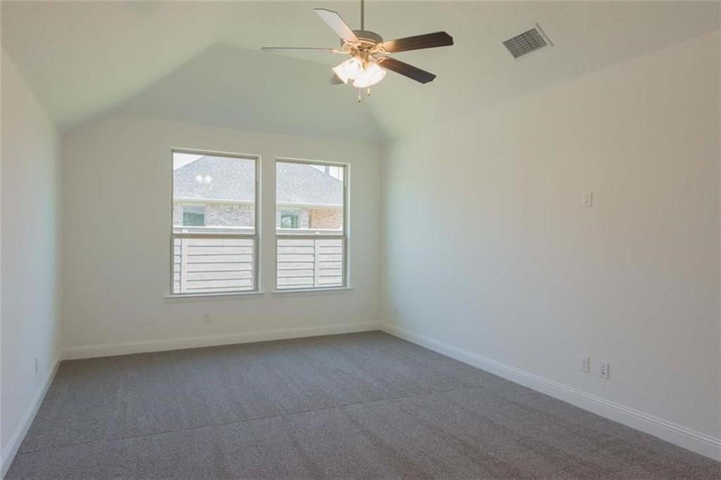 867 Forest Street Little Elm, TX 76227 - Photo 14 of 22 an empty room with a window and a fan