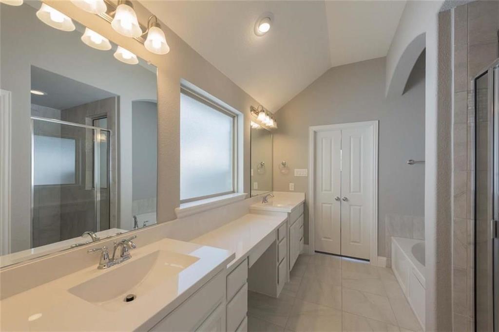 867 Forest Street Little Elm, TX 76227 - Photo 16 of 22 a bathroom with a sink a vanity and a mirror