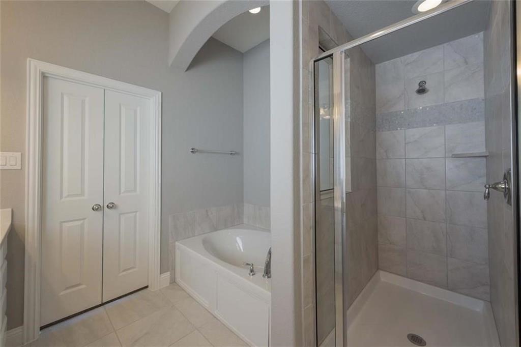 867 Forest Street Little Elm, TX 76227 - Photo 17 of 22 a bathroom with a bathtub