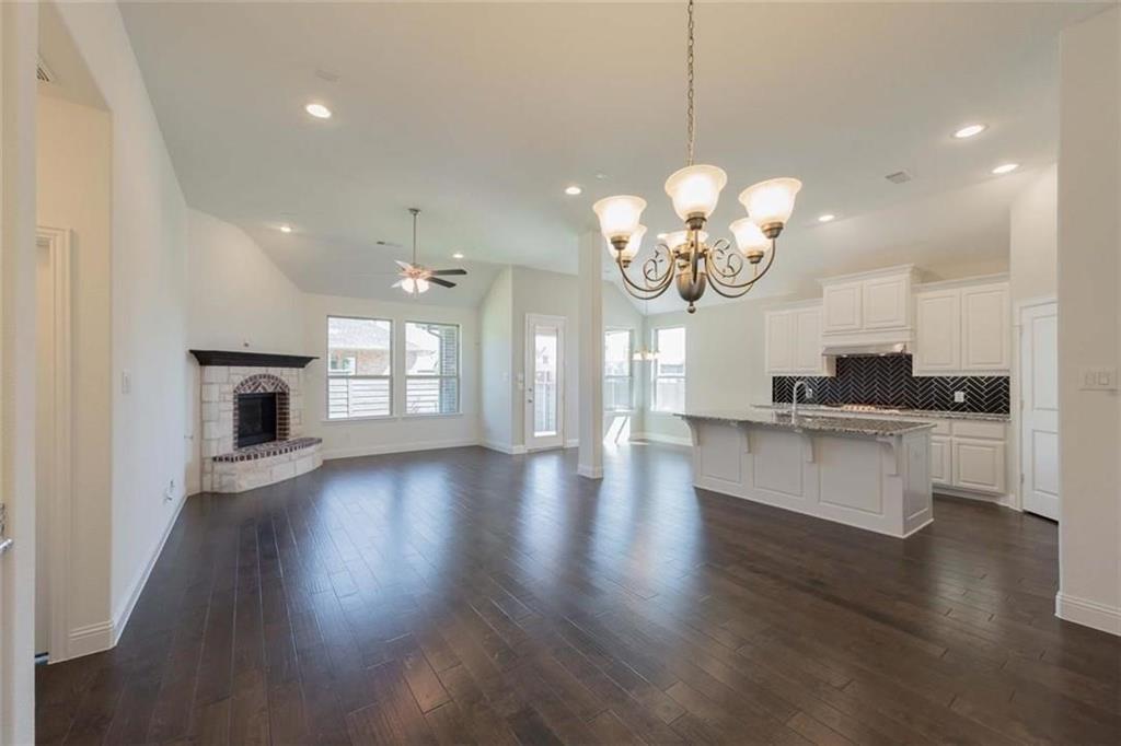 867 Forest Street Little Elm, TX 76227 - Photo 22 of 22 a view of a kitchen and a chandelier wooden floor kitchen view