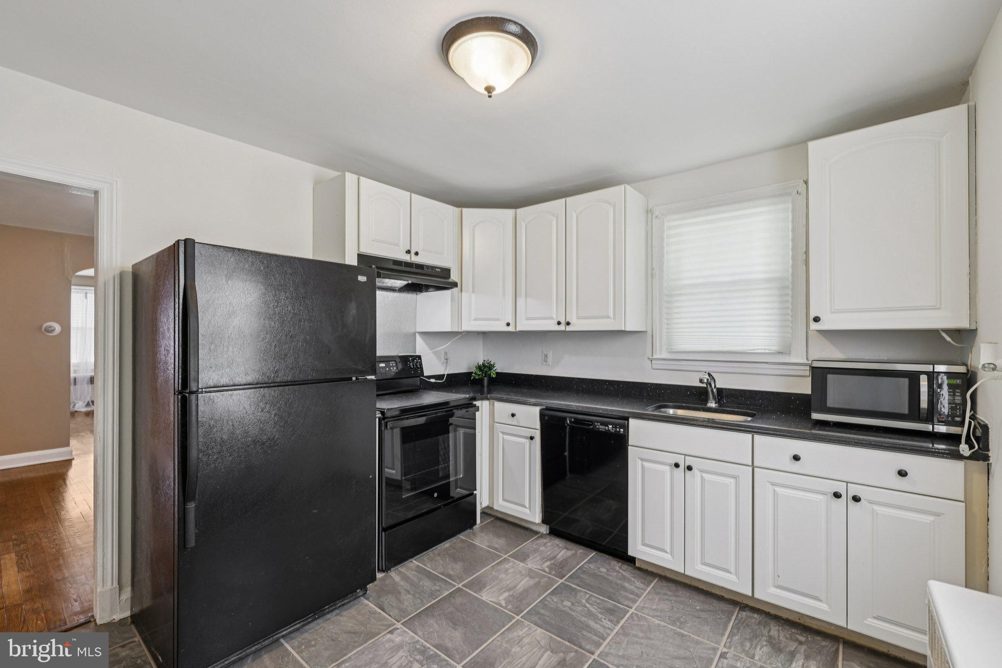 6907 Moyer Avenue Baltimore, MD 21234 - Photo 12 of 48 Modern kitchen with sleek black appliances.