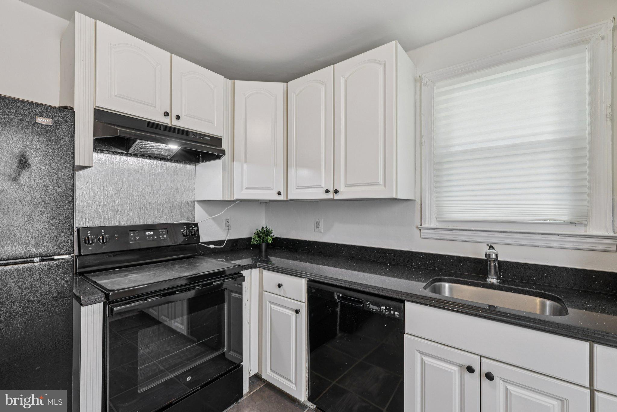 6907 Moyer Avenue Baltimore, MD 21234 - Photo 16 of 48 Modern kitchen with sleek black accents.