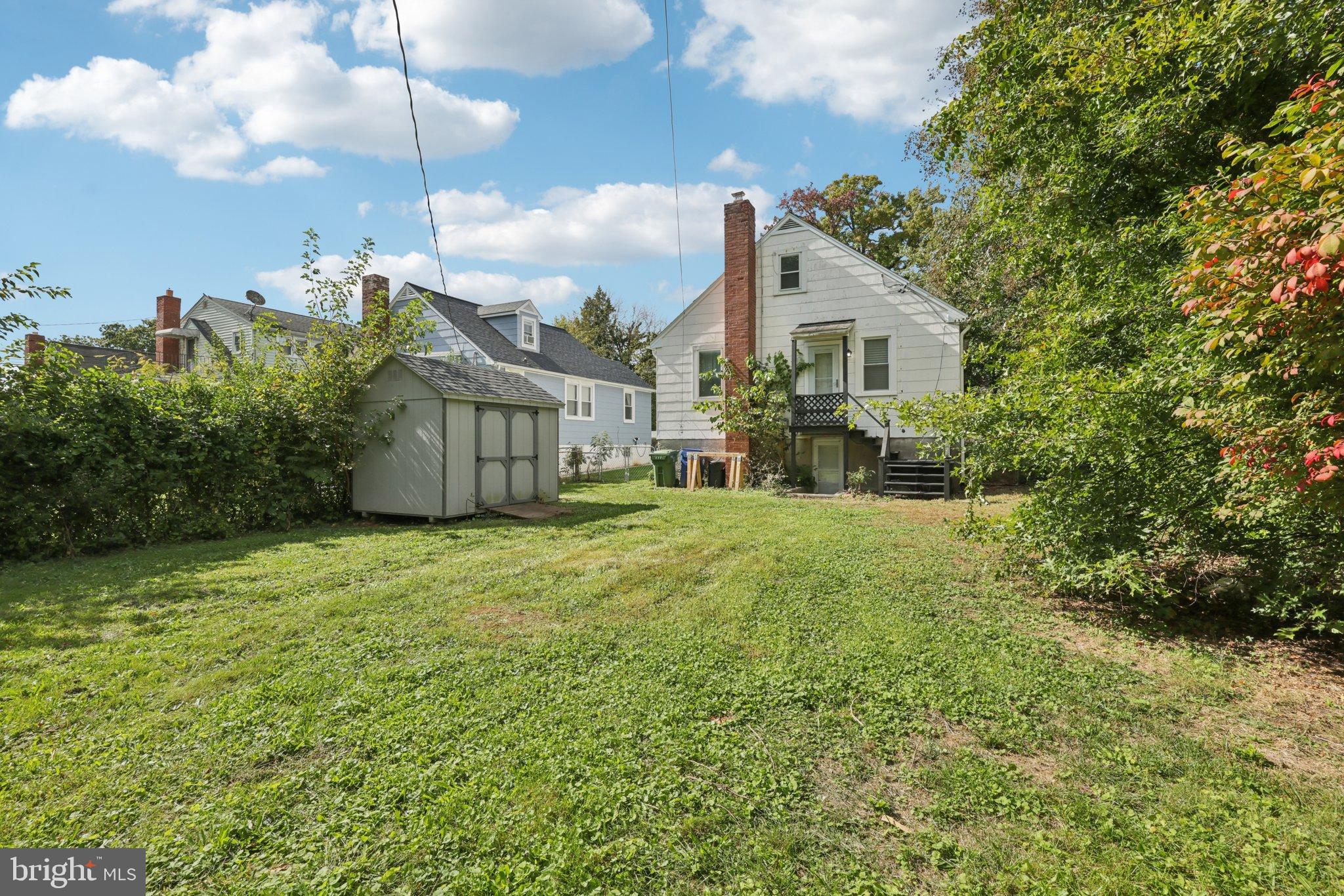 6907 Moyer Avenue Baltimore, MD 21234 - Photo 35 of 48 Charming backyard oasis with lush greenery.