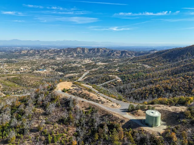 a view of a field with mountains in the background