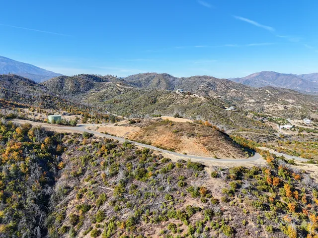 a view of a field with mountains in the background