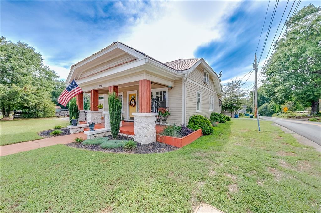 a view of a house with a yard porch and sitting area
