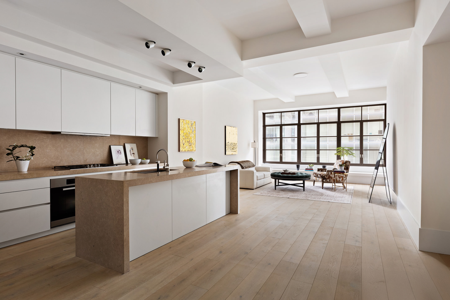 a open kitchen with white cabinets and wooden floor
