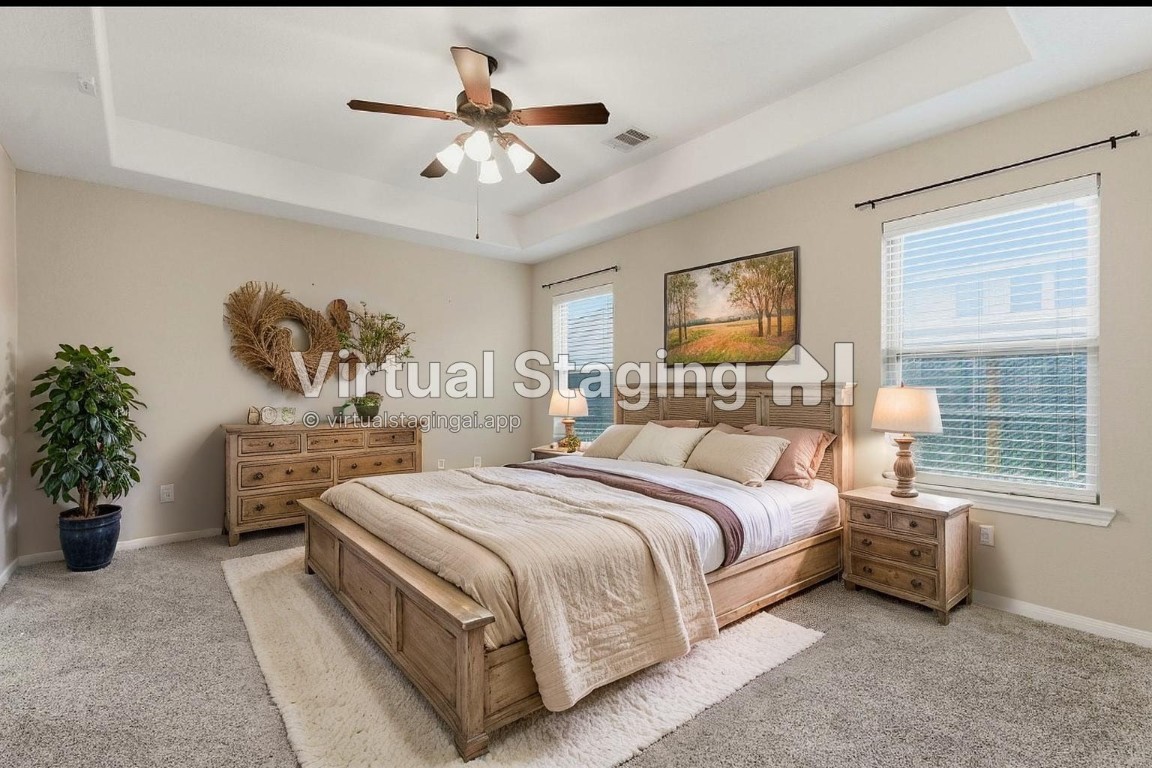 21822 Mount Hunt Drive Spring, TX 77388 - Photo 15 of 26 Spacious and elegantly virtually staged primary bedroom with abundant natural light and chic decor.