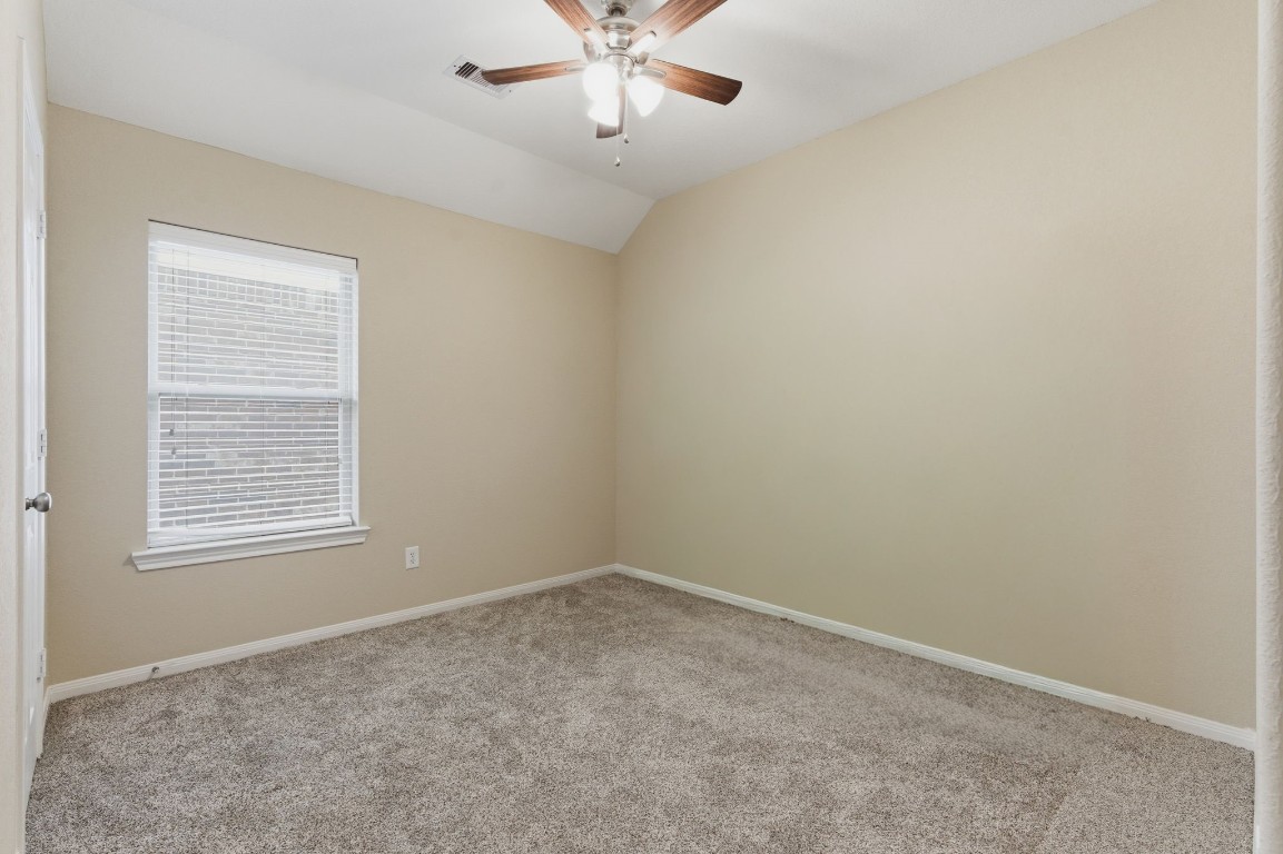 21822 Mount Hunt Drive Spring, TX 77388 - Photo 19 of 26 Spacious second bedroom with natural light and a cozy atmosphere.