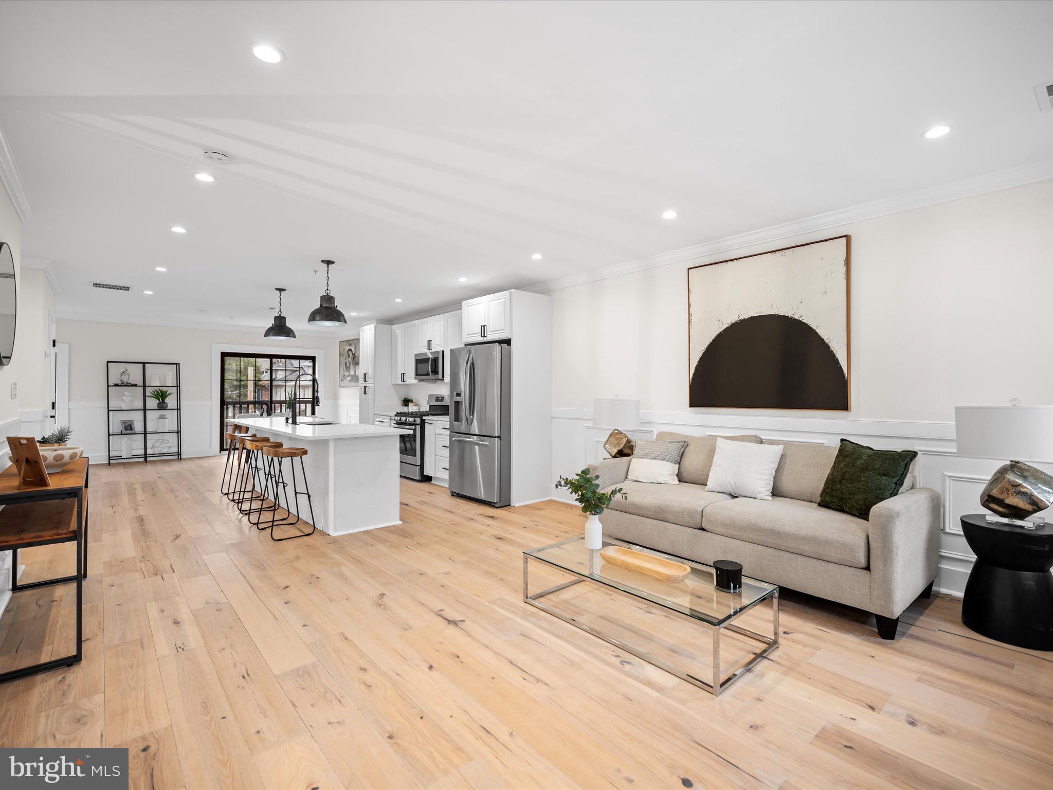 a living room with furniture and kitchen view