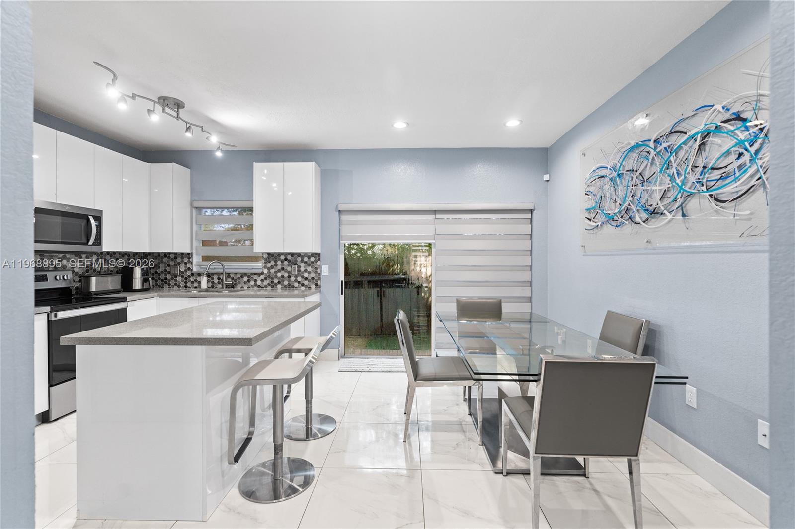 1621 Southeast 30th Street Homestead, FL 33035 - Photo 8 of 20 a kitchen with granite countertop white cabinets and stainless steel appliances