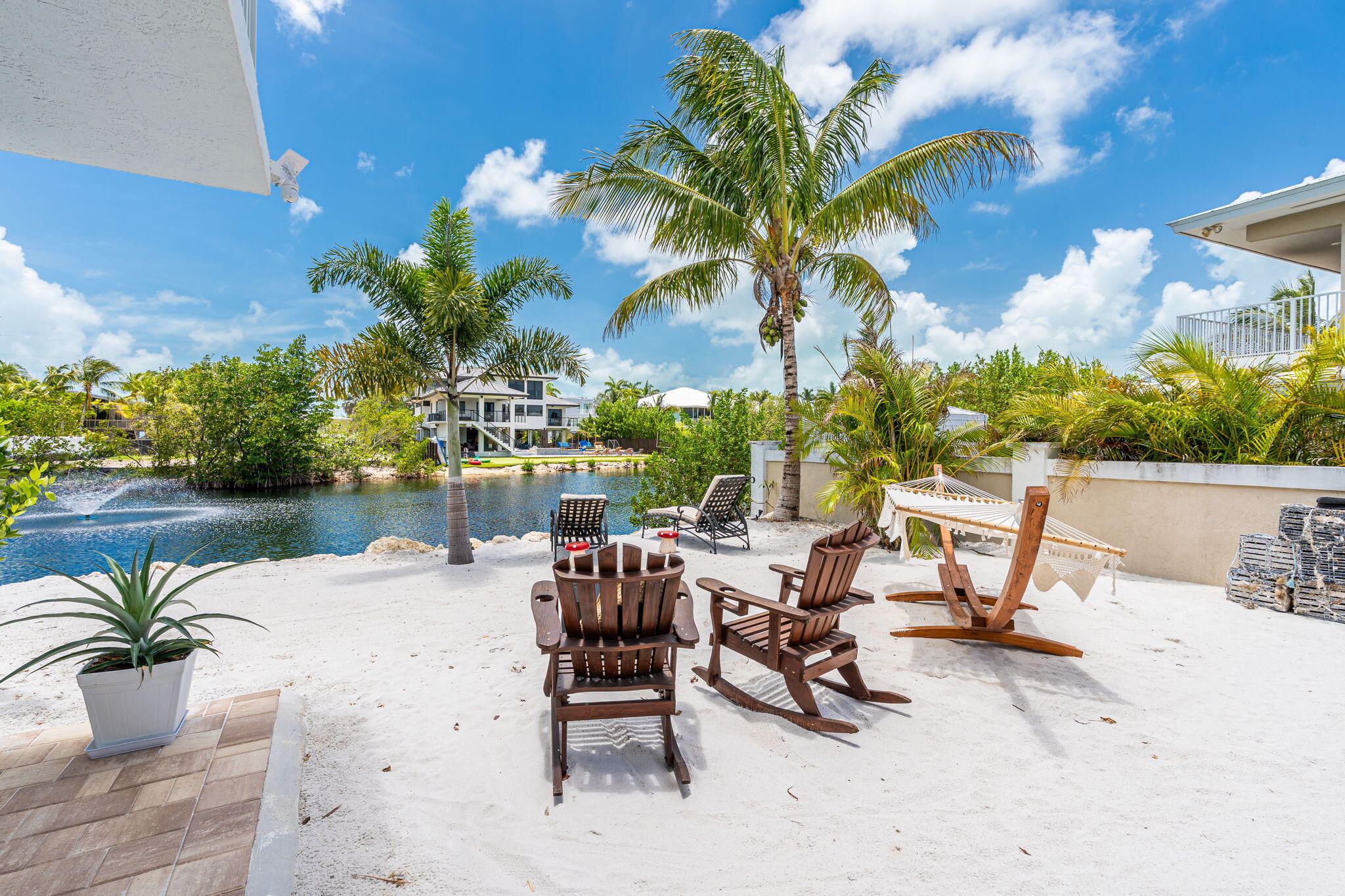 24 Mutiny Place Key Largo, FL 33037 - Photo 9 of 69 a view of a swimming pool with a lounge chair and a fire pit
