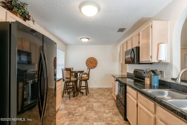 a kitchen with a table and chairs in it
