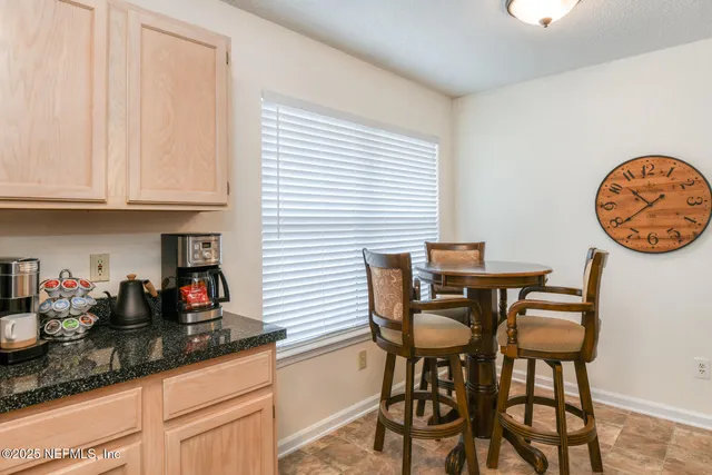 a view of a dining room with furniture wooden floor and a chandelier