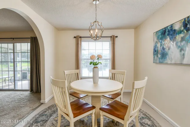 a dining room with furniture and chandelier