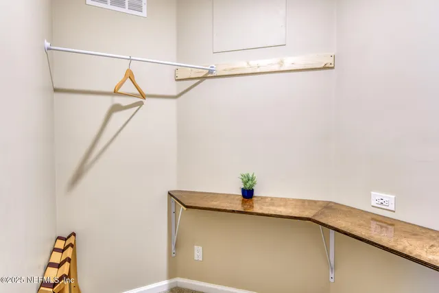 a room with a dryer and cabinets