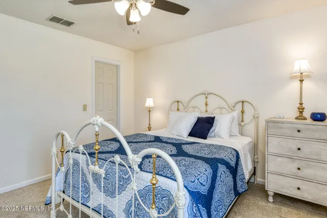 a bedroom with a bed and a table