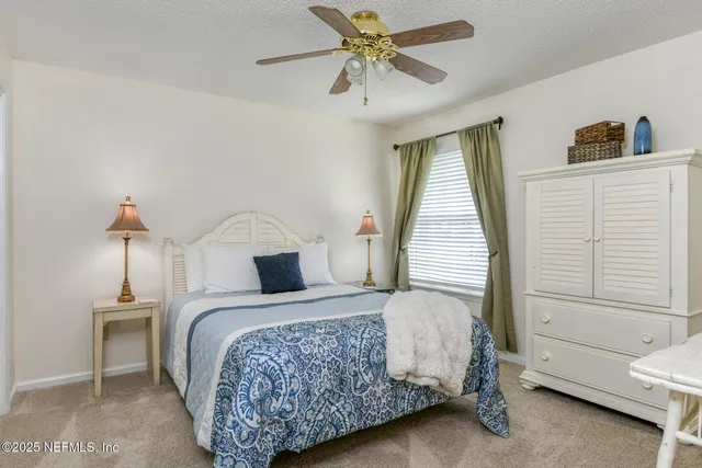 a bathroom with a granite countertop sink a toilet and a mirror