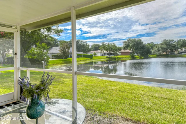 a view of a lake with houses in the back