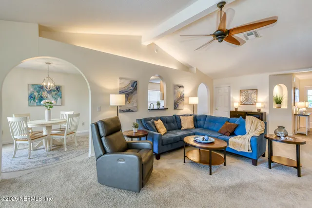 a living room with furniture and a lamp
