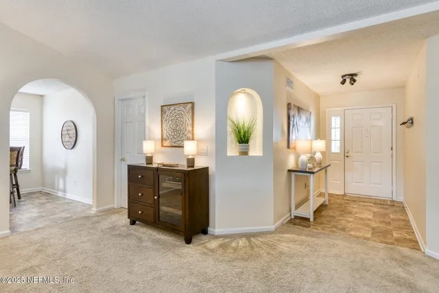 a living room with a fireplace furniture and a flat screen tv