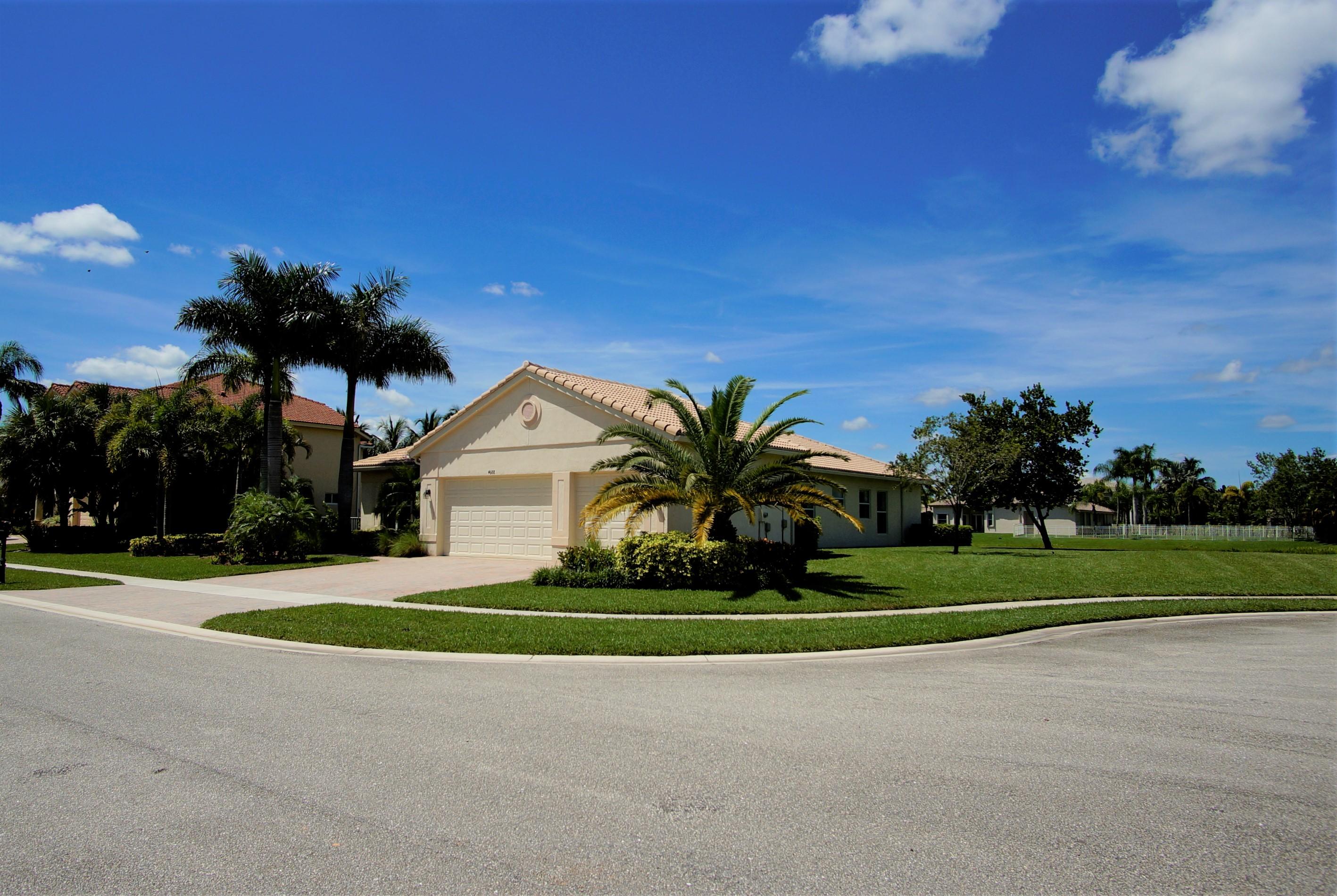 4688 Manderly Drive Wellington, FL 33449 - Photo 2 of 55 a front view of a house and a garden