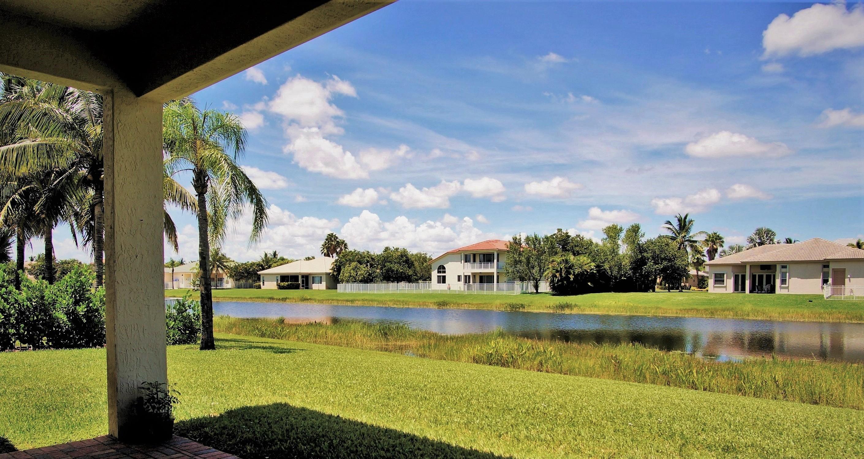4688 Manderly Drive Wellington, FL 33449 - Photo 18 of 55 a view of a lake with houses in the background