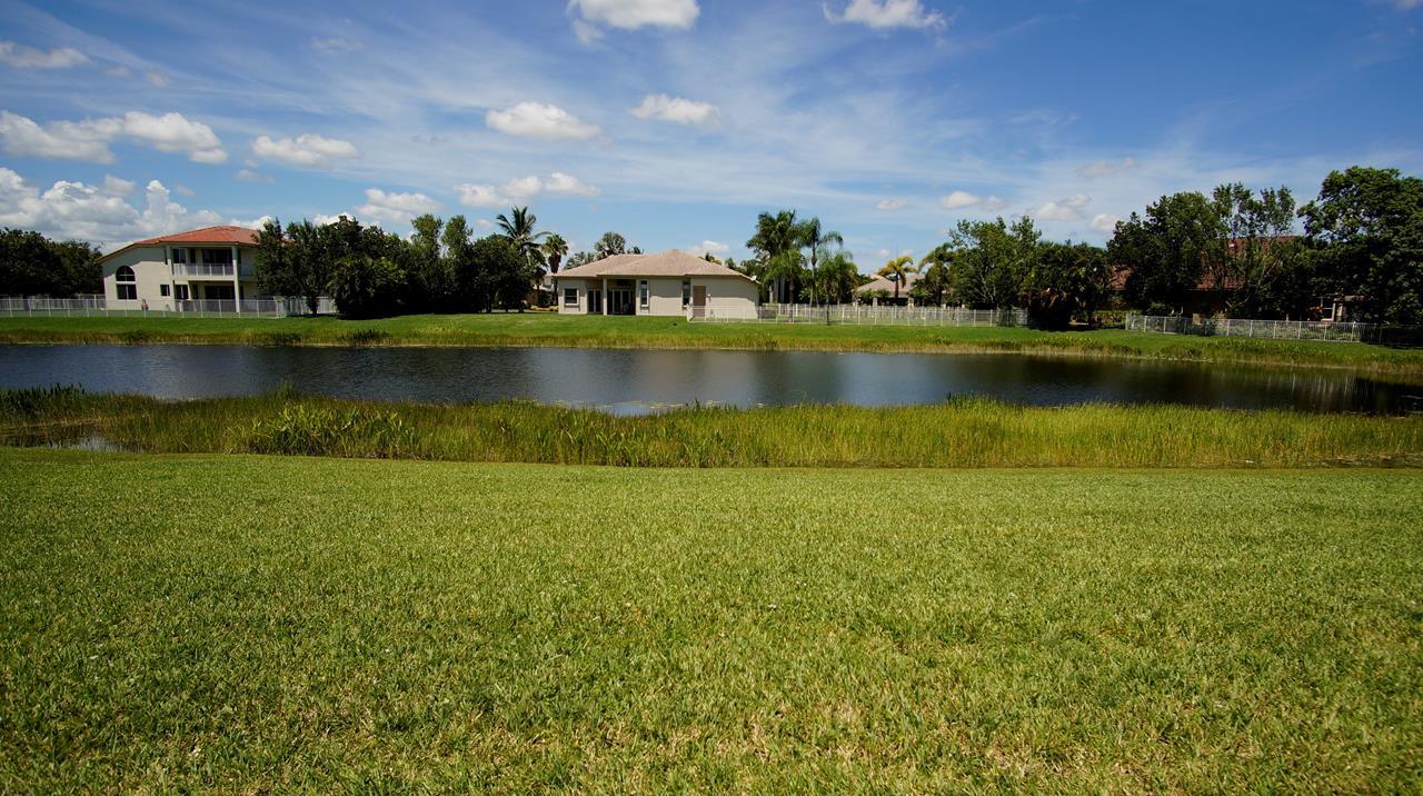 4688 Manderly Drive Wellington, FL 33449 - Photo 19 of 55 an aerial view of a house with a yard and lake view